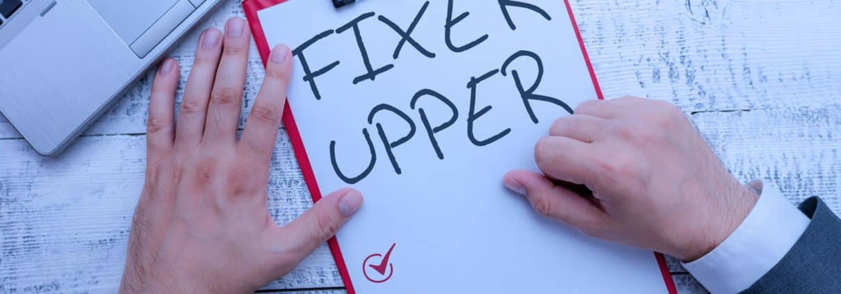 Homeowner reading fixer upper checklist on clipboard